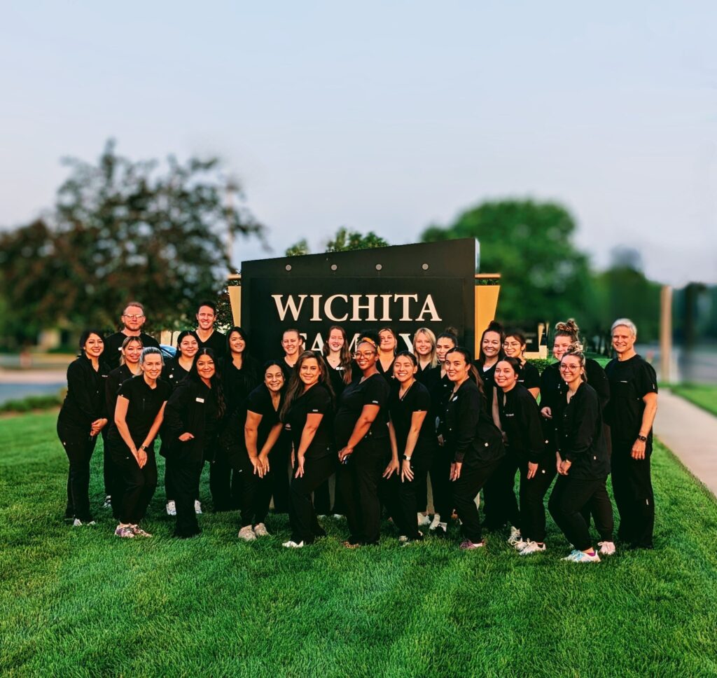 Square photo of the Wichita Family Dental team in front of the street sign, capturing their collective commitment to dental health.