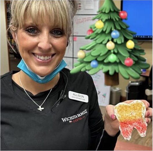 Wichita Family Dental employees decorating Christmas cookies, showcasing team bonding and festive spirit.