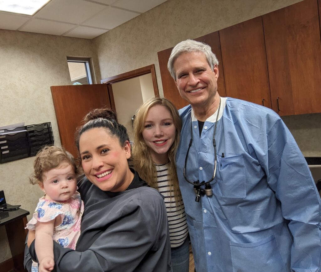Dr. Pierson posing with patients and an employee at Wichita Family Dental, showcasing the clinic's community.