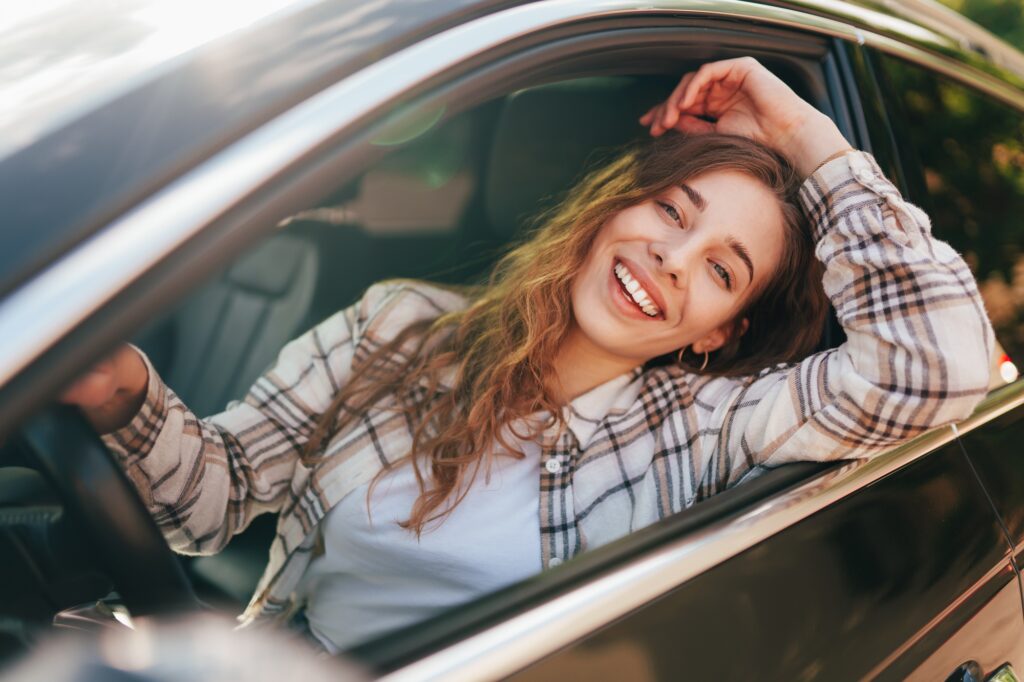 Smiling woman in car after dental cleaning in Wichita, showing confidence and oral health from routine care at Wichita Family Dental