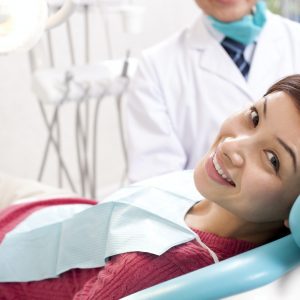 Female patient smiling in the exam chair at Wichita Family Dental, receiving personalized dental treatment.